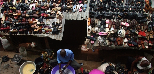 Adam Cohn / Used shoes rinsed off and dried in the sun, Kumasi, Ghana.