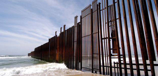 The border fence separating Mexico and the United States extends out into the Pacific Ocean at the beach in Tijuana. Many Mexicans migrants have drowned in the strong currents while trying to enter the US illigally.